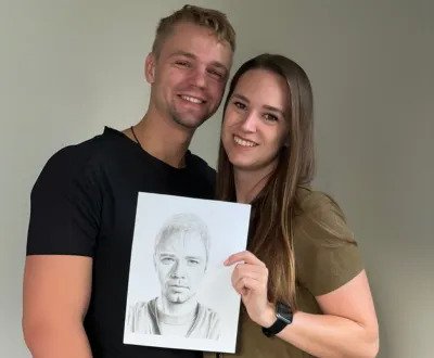 Couple holding pencil sketch of soulmate from Eva Bloom psychic artist